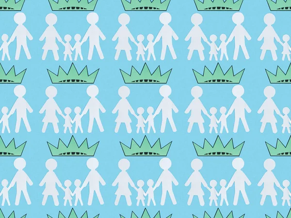 Seamless background pattern with white paper cut families and crowns on blue, Independence Day concept — Stock Photo