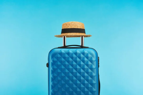 Blue colorful travel bag with handle on wheels on blue background — Stock Photo