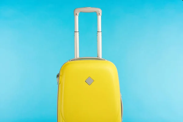 Gelbe, bunte Reisetasche mit Henkel isoliert auf blau — Stockfoto