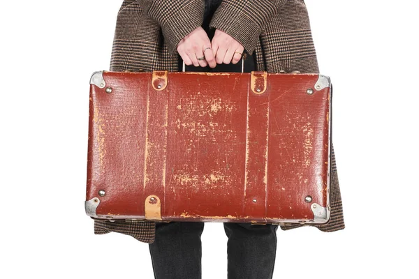 Partial view of woman in checkered coat holding vintage weathered suitcase isolated on white — Stock Photo