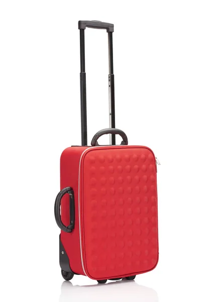 Red textured colorful suitcase with handle on wheels isolated on white — Stock Photo