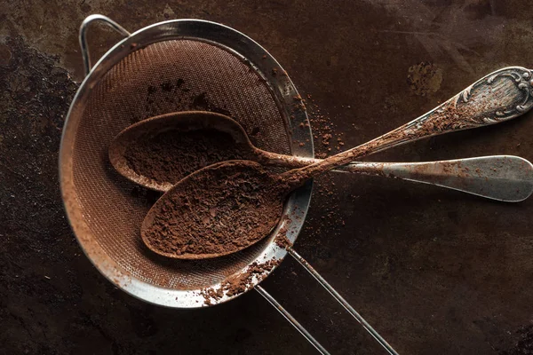 Top view of dirty strainer and vintage spoons on rust metal background — Stock Photo