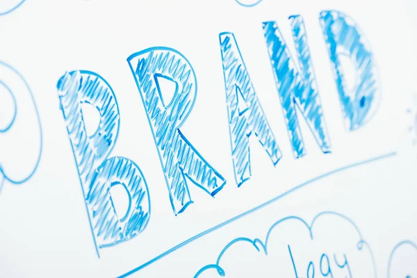 Close up view of word brand written on white flipchart — Stock Photo