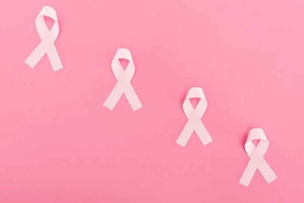 Flat lay with pink breast cancer signs on pink background — Stock Photo