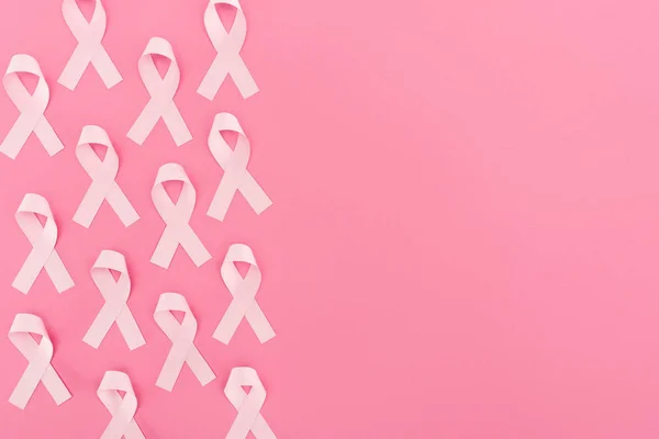Top view of pink breast cancer signs on pink background with copy space — Stock Photo