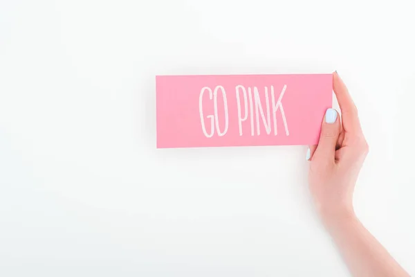 Partial view of woman holding pink card with go pink lettering on white background with copy space — Stock Photo