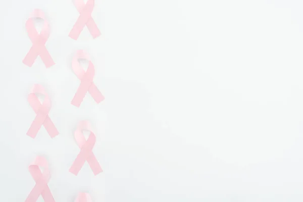 Top view of silk pink breast cancer signs on white background with copy space — Stock Photo