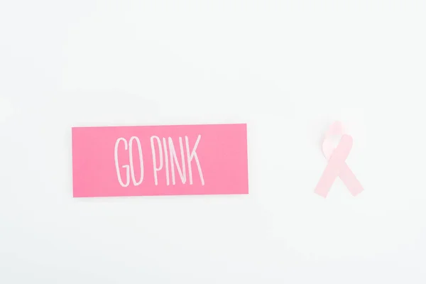 Top view of pink breast cancer sign and card with go pink lettering on white background — Stock Photo