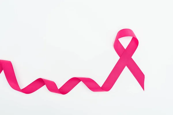 Top view of curved crimson breast cancer ribbon on white background — Stock Photo
