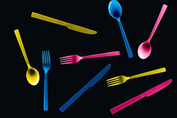 Bottom view of colorful plastic cutlery isolated on black — Stock Photo