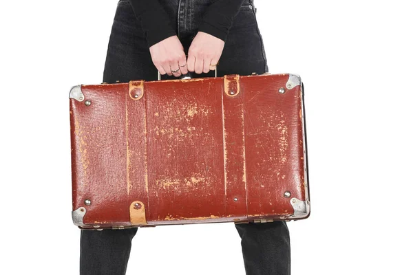 Cropped view of girl in jeans holding vintage suitcase isolated on white — Stock Photo