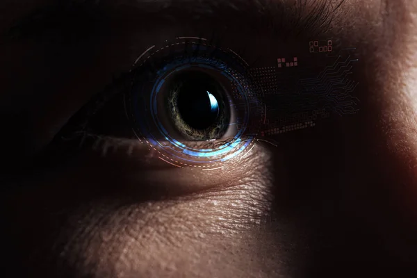 Close up view of human eye with data illustration in darkness, robotic concept — Stock Photo