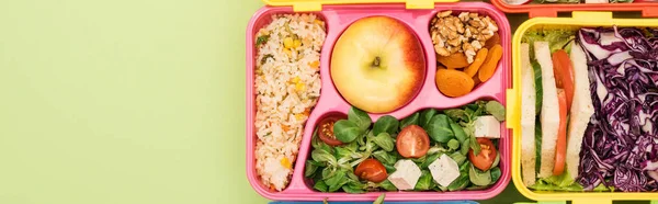 Panoramic shot of lunch boxes with food — Stock Photo