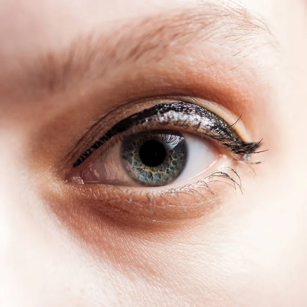 Close up view of woman blue eye looking at camera — Stock Photo