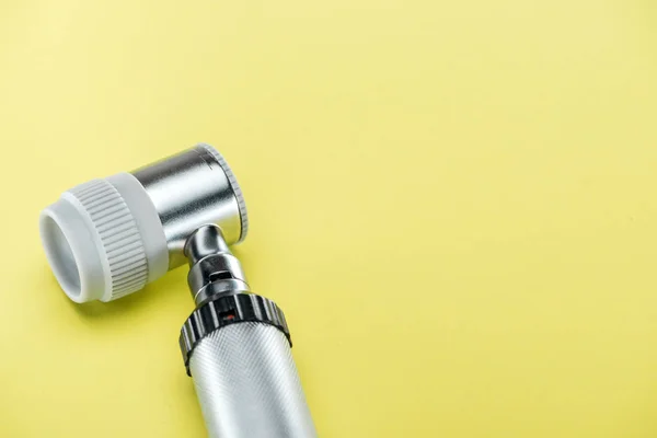 Close up view of dermatoscope on yellow background — Stock Photo