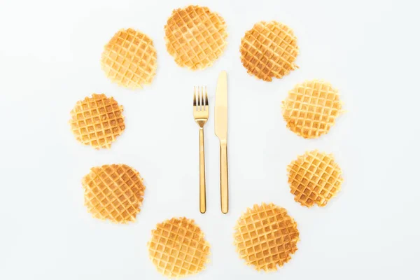 Top view of waffles in circle with fork and knife in middle isolated on white — Stock Photo