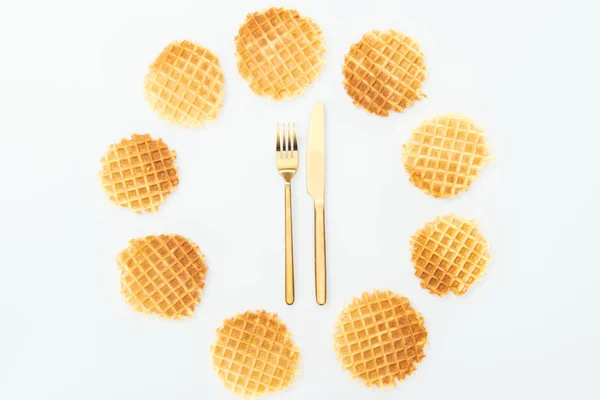 Vista superior de waffles em círculo com garfo e faca no meio isolado em branco — Fotografia de Stock