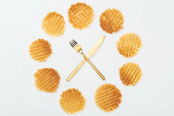 Top view of waffles with fork and knife in middle isolated on white — Stock Photo