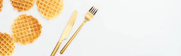 Panoramic shot of waffles and golden cutlery isolated on white — Stock Photo