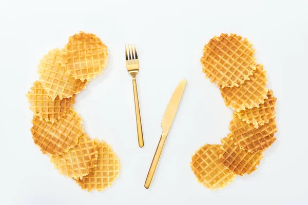 Top view of cutlery rounded by waffles on white — Stock Photo