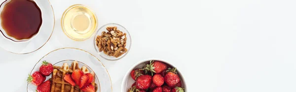 Panoramic shot of breakfast with strawberries and waffle on white — Stock Photo