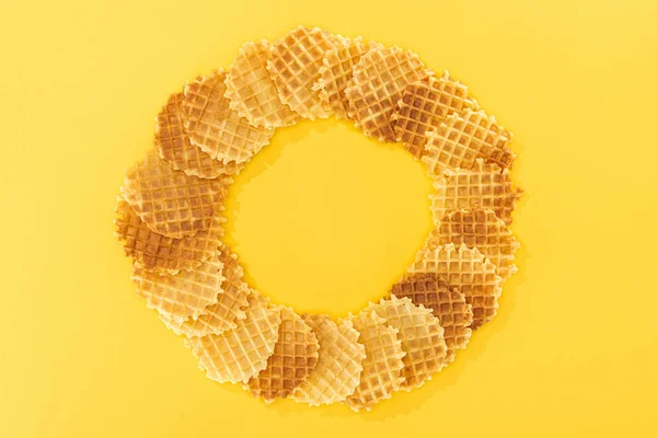 Top view of tasty waffles in circle with emptiness in middlr on yellow — Stock Photo