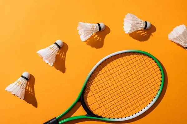 Top view of shuttlecocks near badminton racket on yellow — Stock Photo