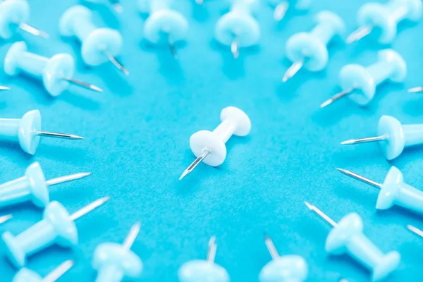 Enfoque selectivo de clip de papel blanco en medio de clips de papel azul sobre fondo azul, concepto de violencia - foto de stock