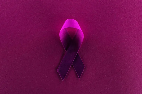 Top view of purple ribbon on purple background in shadow — Stock Photo