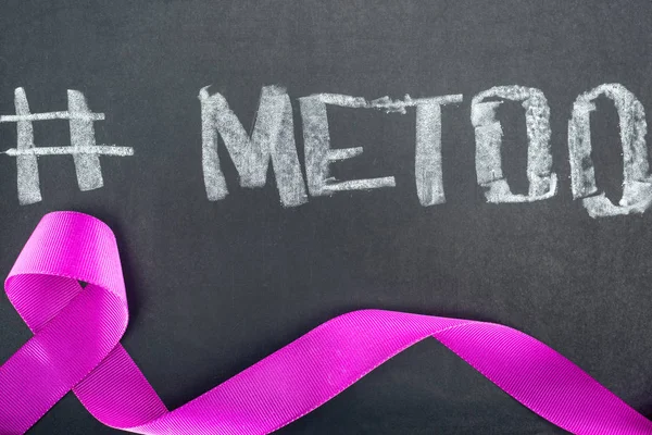 Top view of domestic violence purple awareness ribbon on chalkboard with hashtag me too — Stock Photo