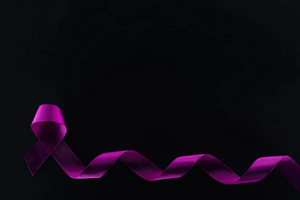 Top view of purple ribbon on black background, violence concept — Stock Photo