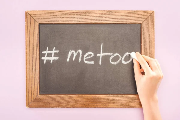 Cropped view of woman writing hashtag me too with chalk on chalkboard isolated on pink — Stock Photo