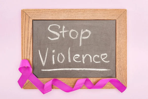 Top view of long purple ribbon on blackboard with inscription isolated on pink — Stock Photo