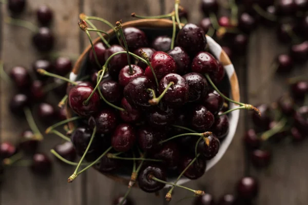 Top view of red, fresh, whole and ripe cherries covered with droplets on bowl — Stock Photo