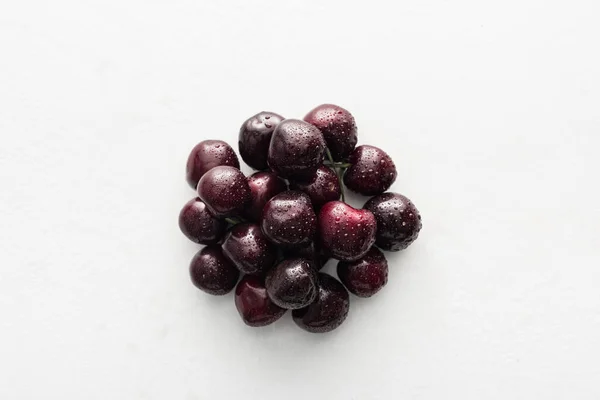 Vue de dessus des cerises fraîches, entières et mûres recouvertes de gouttes d'eau — Photo de stock