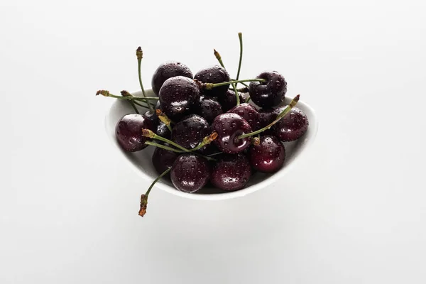 Red, whole and ripe cherries covered with water drops on bowl — Stock Photo