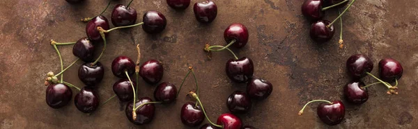 Panoramic shot of fresh, sweet, red and ripe cherries on stoned background — Stock Photo