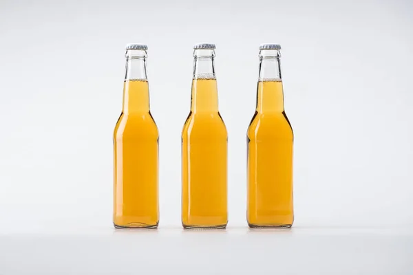 Botellas de cerveza en fila sobre fondo blanco - foto de stock