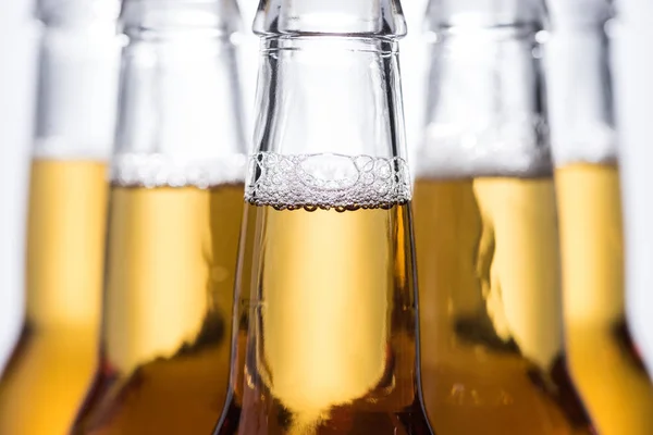 Selective focus of beer bottles with bubbles — Stock Photo