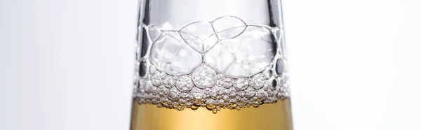 Close up view of beer bottle with bubbles isolated on white, panoramic shot — Stock Photo