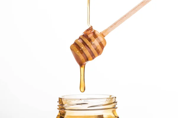 Wooden honey dipper with dripping sweet honey isolated on white — Stock Photo