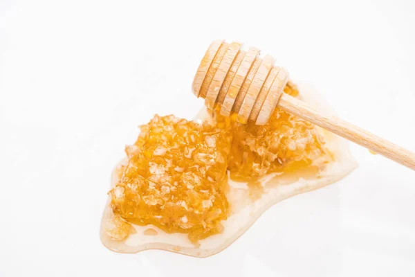 Honeycomb with sweet delicious honey and wooden honey dipper isolated on white — Stock Photo
