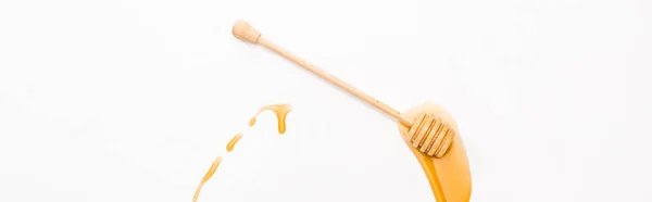 Panoramic shot of honey and wooden honey dipper isolated on white — Stock Photo