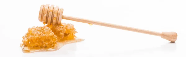 Panoramic shot of honeycomb with sweet honey and wooden honey dipper isolated on white — Stock Photo