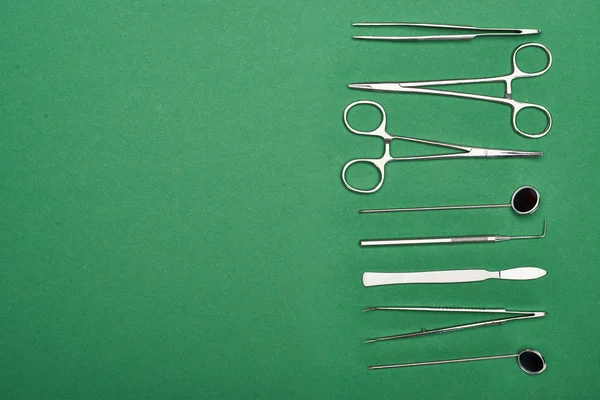 Top view of set with dental tools and scissors isolated on green — Stock Photo