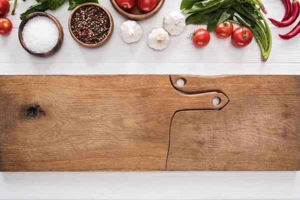 Vue du dessus des planches à découper, tomates cerises, verdure, piments, sel, ail et épices — Photo de stock