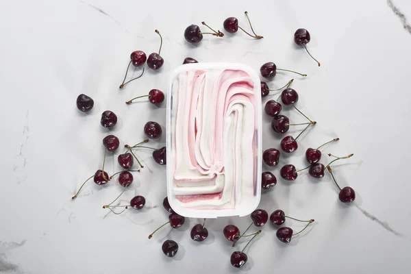 Top view of delicious ice cream with cherries on marble grey background — Stock Photo