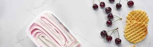 Top view of delicious waffles, cherries and ice cream on marble grey background, panoramic shot — Stock Photo