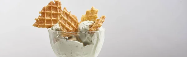 Delicious pistachio ice cream with waffles isolated on grey, panoramic shot — Stock Photo