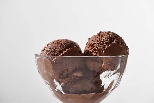 Close up view of fresh delicious chocolate ice cream in glass bowl isolated on grey — Stock Photo